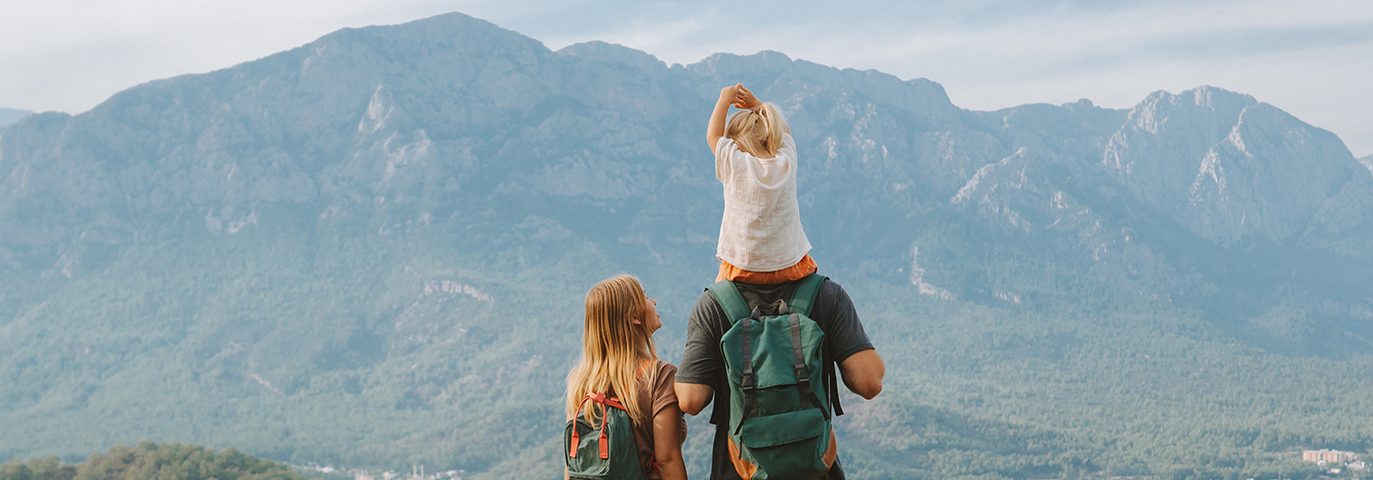 Family hiking parents with child outdoor travel in mountains active vacations lifestyle mother and father backpacking together with baby in Turkey