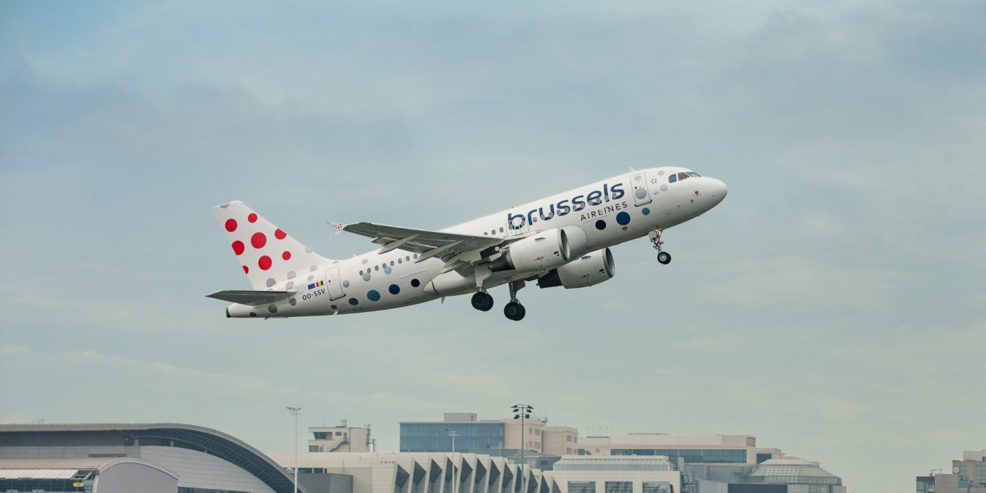 A Brussels Airlines airplane taking off into a cloudy sky.