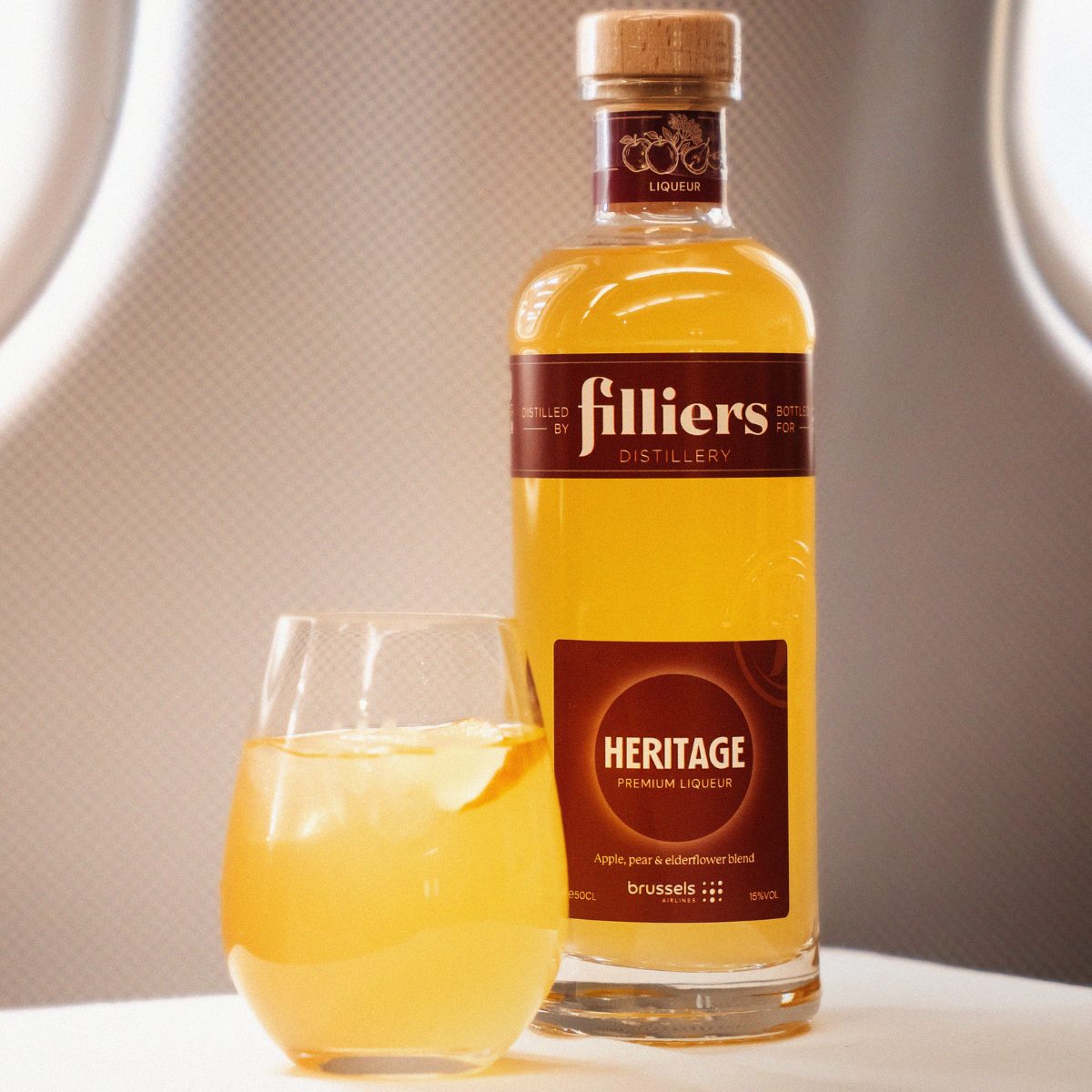 Filliers Heritage genever bottle and signature drink on an airplane tray.