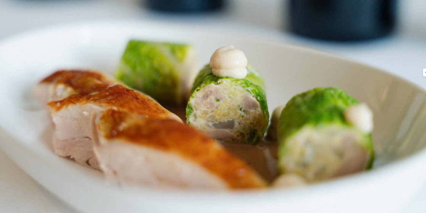 An elegantly arranged, exclusive gourmet dish on a white plate.