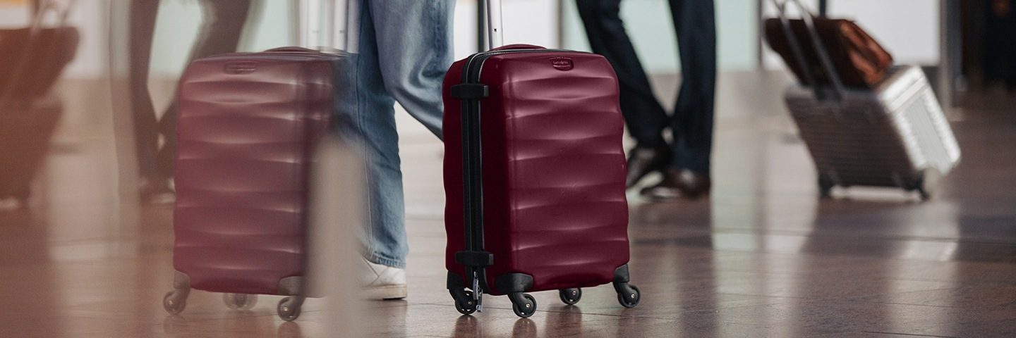 Several individuals gathered with their suitcases and bags.