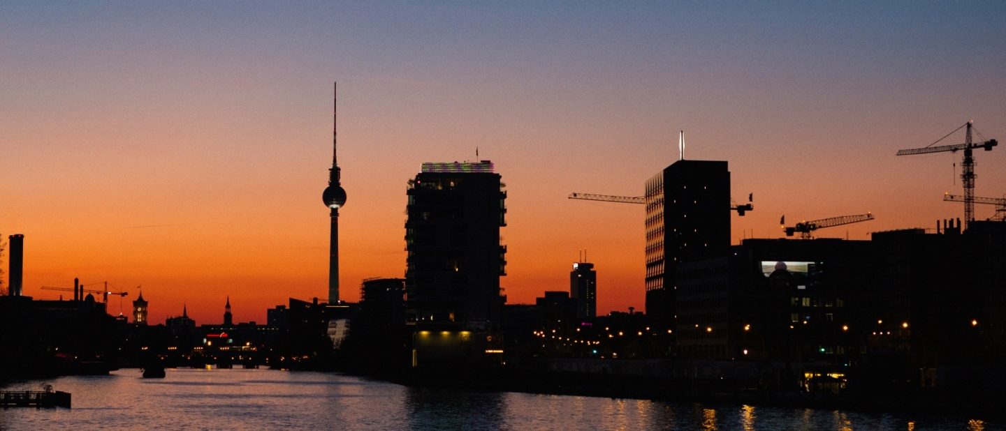 City buildings illuminated by the warm tones of a sunset.