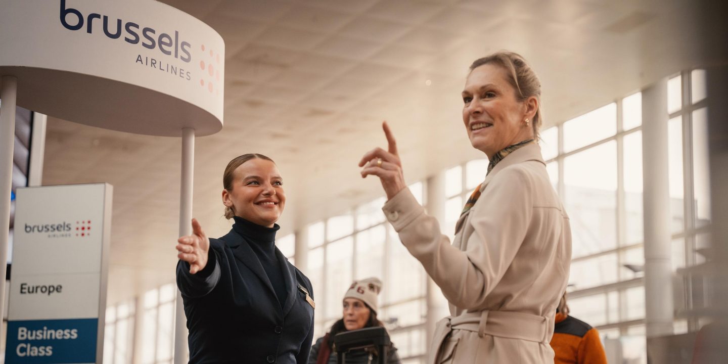 Brussels Airlines staff assists a traveler at the airport check-in desk.