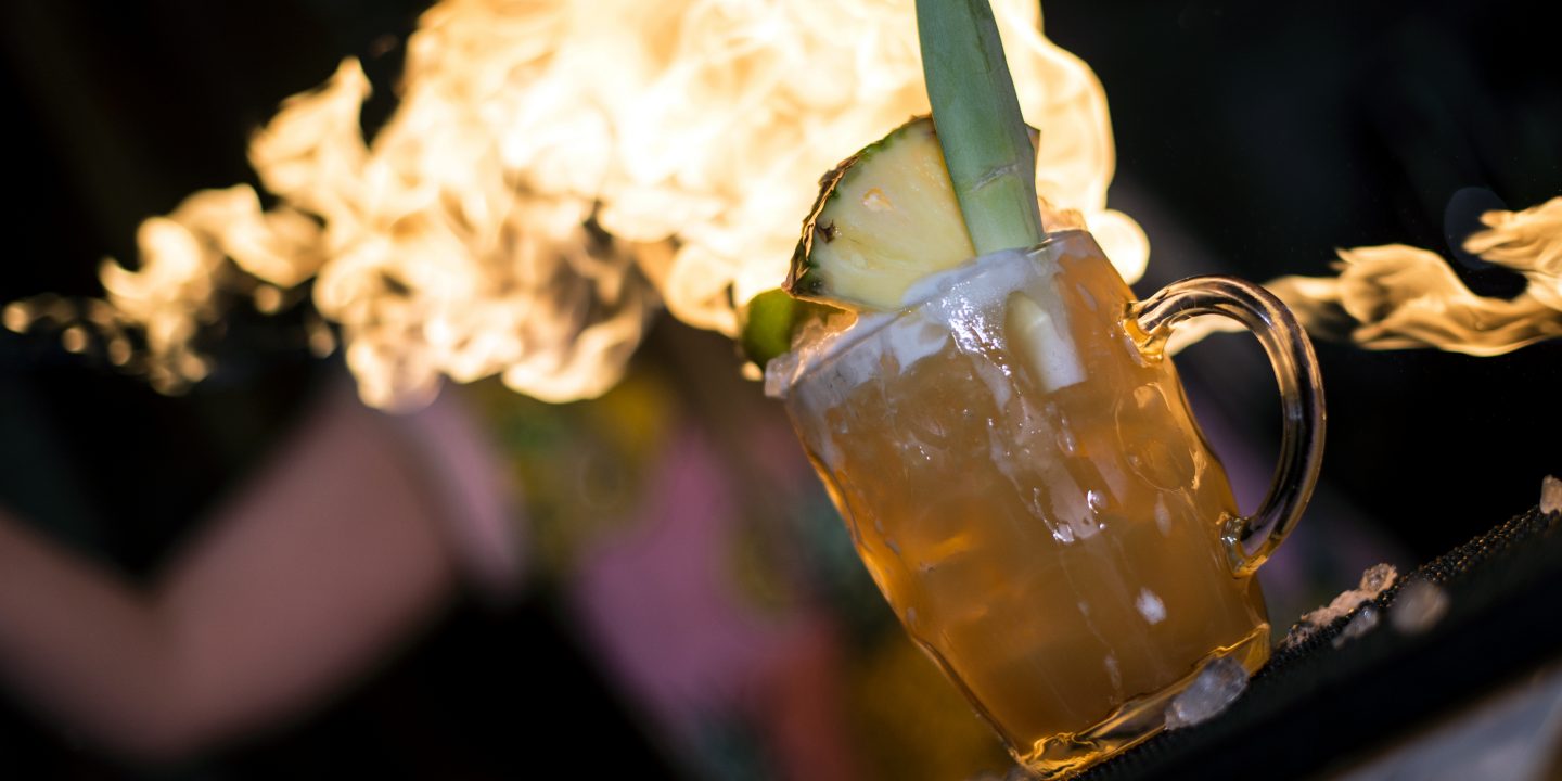 Bar tender throws fire across a Zombie cocktail